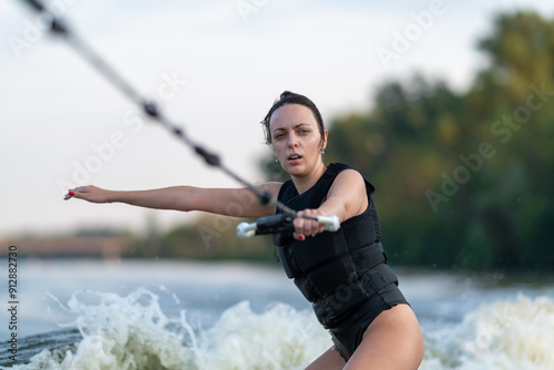 Obraz na płótnie A young woman surfing on a river. w salonie