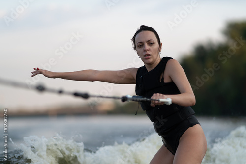 Obraz na płótnie Surfing is being done by a girl on a river. w salonie