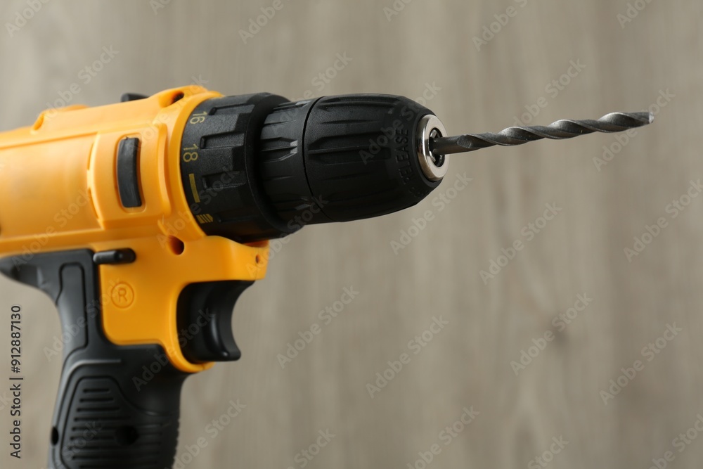 One cordless electric drill against blurred background One cordless electric drill against blurred background