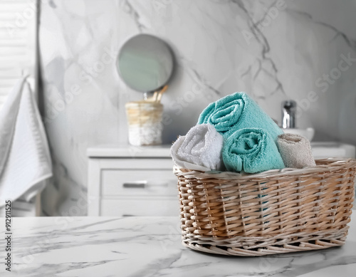 Spaworthy relaxation Wicker basket with clean soft towels in bathroom photo