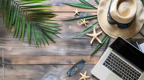 Laptop, Straw Hat, and Starfish on Wooden Table. Top view, flay lay photo