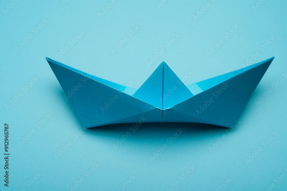 Paper on blue with a boat. concept business competition concept. blue and white paper with a ship in the. paper on a blue with a lifestyle boat. Paper on blue with a boat. concept business competition concept. blue and white paper with a ship in the. paper on a blue with a lifestyle boat.