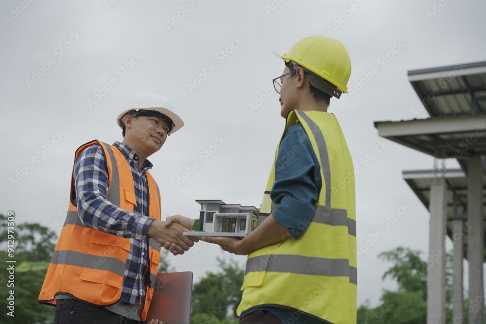 Professional architect engineer with hard hat and blueprint at building construction site house building permit background. Architects looking at blueprints. Construction and engineering industry Professional architect engineer with hard hat and blueprint at building construction site house building permit background. Architects looking at blueprints. Construction and engineering industry
