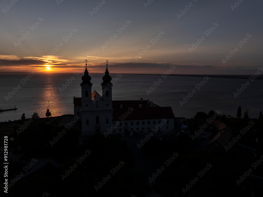 Obraz premium Aerial skyline view of the famous Benedictine Monastery of Tihany (Tihany Abbey) with beautiful colourful sky and clouds at sunrise