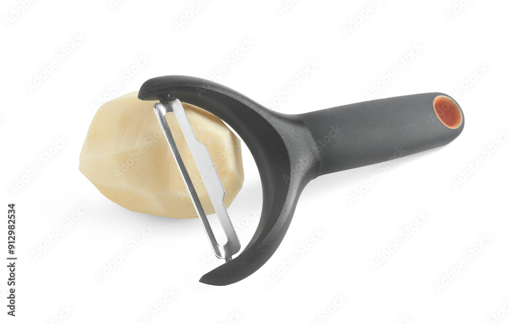 Fresh raw potato and peeler isolated on white Fresh raw potato and peeler isolated on white