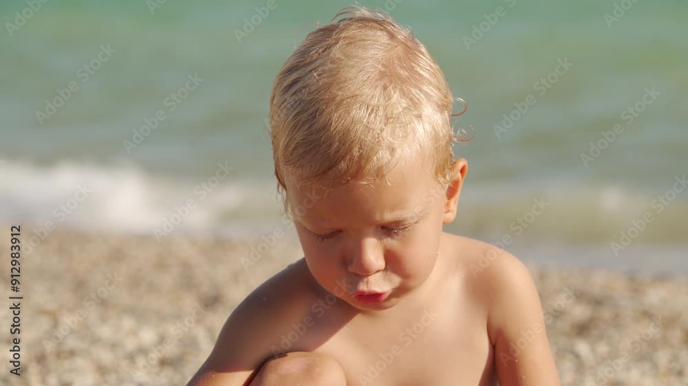 Little boy playing on the beach in summer. Child face close-up by the sea. Yevpatoriya, Crimea, Russia 2024 Little boy playing on the beach in summer. Child face close-up by the sea. Yevpatoriya, Crimea, Russia 2024