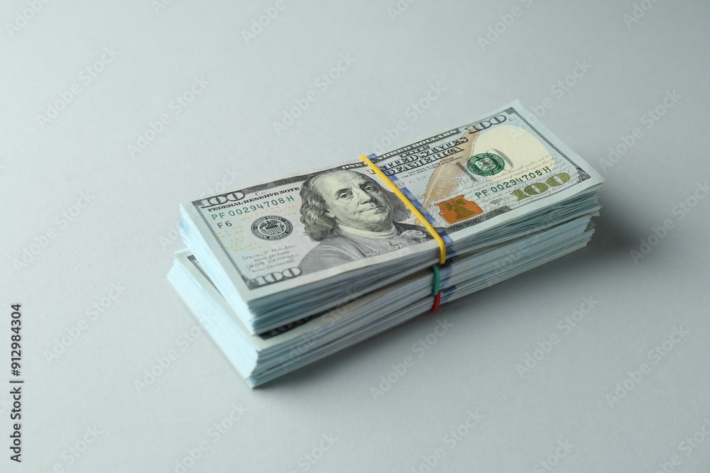 Bundles of dollar banknotes on light grey background Bundles of dollar banknotes on light grey background