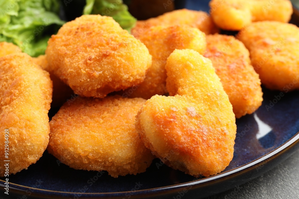 Tasty chicken nuggets on grey table, closeup Tasty chicken nuggets on grey table, closeup