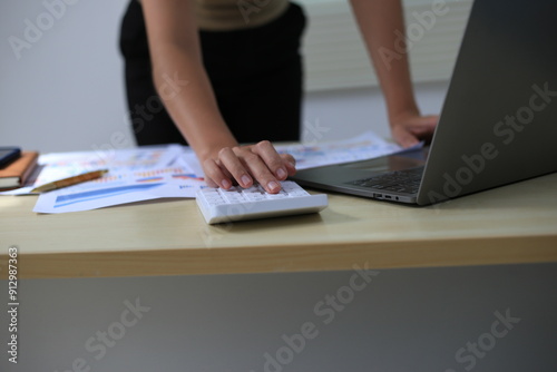 Successful Asian businesswoman sitting at desk working using laptop computer in office. Business and people concept. Businesswoman using laptop computer and working with documents.