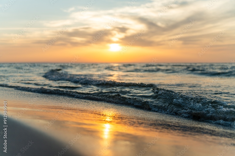 Fototapeta premium Scenic view of sunset over a calm ocean