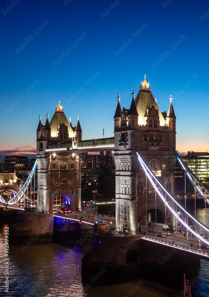 Obraz premium Historic Bridge over River Thames and Cityscape Skyline during dramatic sunset. Tower Bridge in City of London, United Kingdom. Travel Destination.