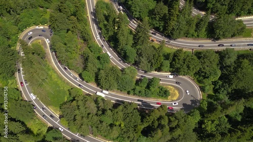 Aerial drone footage of a massive traffic jam on a super windy road in the Romanian Carpathian mountains. High angle shot of trafflic moving slowly and standstill seen from above on a main road DN1.
 photo