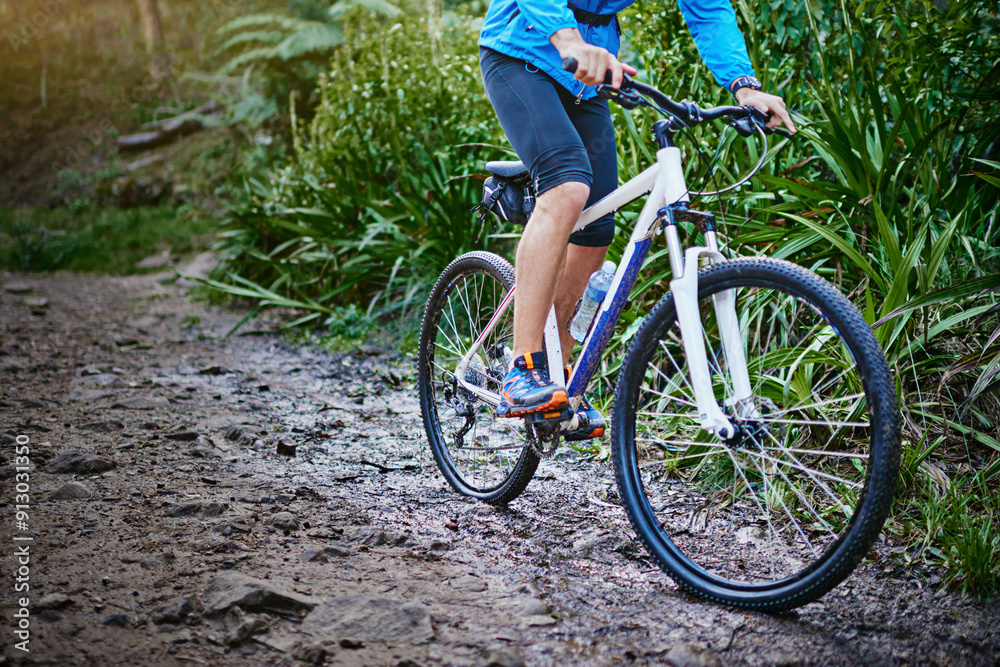 Naklejka premium Person, legs and forest for cycling adventure in outdoor, performance and mountain for extreme sports. Footwear, athlete and training in nature for triathlon, fitness and riding exercise on trail