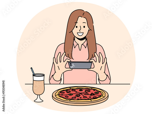 Woman takes picture of pizza on phone, wanting to make post on social network and talk about life. Girl blogger take shot of pizza while visiting restaurant of traditional italian cuisine