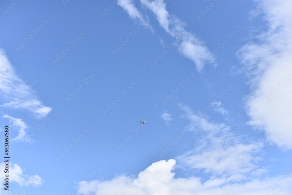 Small plane in the blue sky with clouds Small plane in the blue sky with clouds