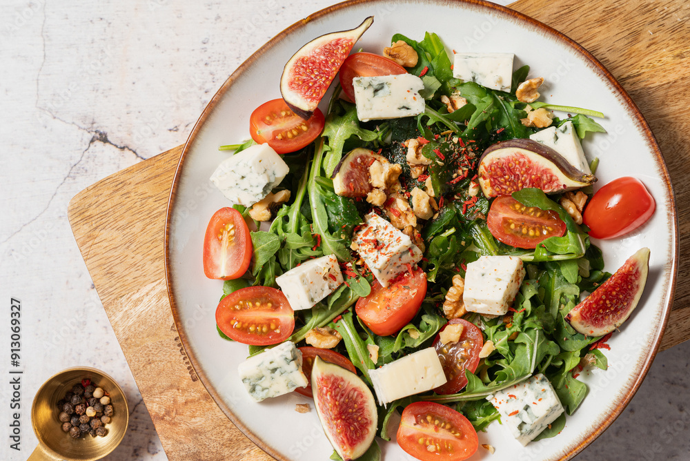 salad with figs, rucola and walnuts. salad with rucola. salad on a light background. salad with blue cheese.
salad with figs, rucola and walnuts. salad with rucola. salad on a light background. salad with blue cheese.