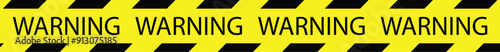 Warning tape with yellow and black diagonal stripes.