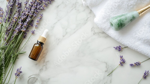 A flat lay of a natural skincare routine with essential oils, a jade roller, fresh lavender, and a white towel on a marble surface, promoting relaxation and self-care, copy space