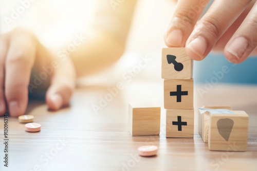 A person is playing with wooden blocks, one of which has an arrow on it. The blocks are stacked on top of each other, with the arrow block on top. Concept of playfulness and creativity