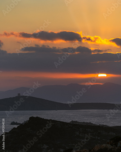 Panorama of a Sardinian sunset, fireball instead of the sun in the clouds photo