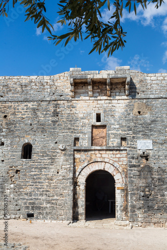 Porto Palermo, Albania - 6 September 2021: Old fortress in Porto Palermo in Albania and Albanian flag