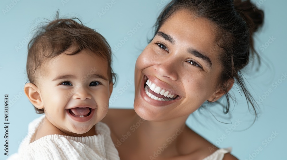Loving studio image of a mother and her beaming baby, highlighting their mutual affection. Loving studio image of a mother and her beaming baby, highlighting their mutual affection.