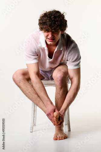 Принти на полотні Young man in suffering from hurtful flatfeet condition