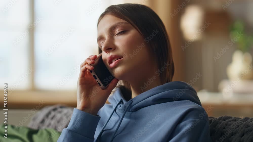 Homely woman talking smartphone sitting sofa living room closeup. Serious lady