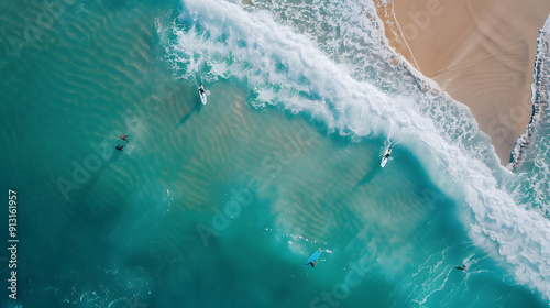 A group of surfers paddling out to catch waves near a sandy beach.