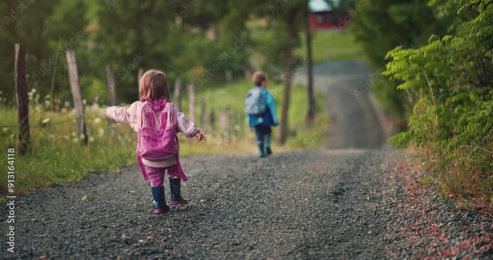 Back to school or kindergarten, boy and girl with backpacks walking together on country road Back to school or kindergarten, boy and girl with backpacks walking together on country road