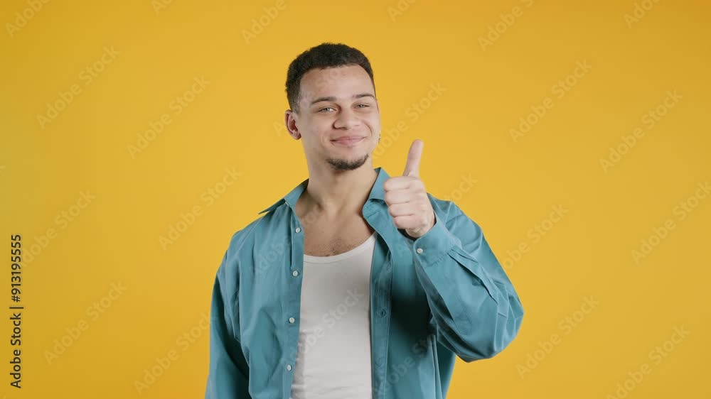 Positive stylish biracial man with LIKE sign, thumbs up gesture. Happy hipster.