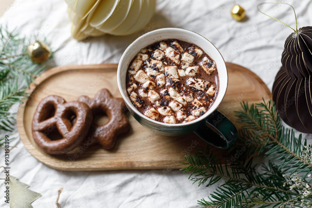 Christmas background. Cup of hot chocolate with marshmallow and cookies, christmas ornaments and gift on wooden tray top view. Merry Christmas. Winter hygge Christmas background. Cup of hot chocolate with marshmallow and cookies, christmas ornaments and gift on wooden tray top view. Merry Christmas. Winter hygge