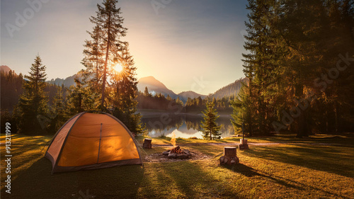 A picturesque camping site in nature with tents and campfire photo