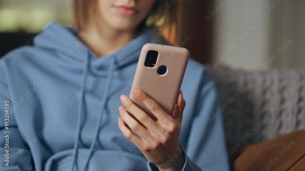 Lady hand holding mobile phone in apartment living room. Unknown woman looking Lady hand holding mobile phone in apartment living room. Unknown woman looking