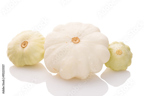 three young and fresh white pattypan squashes