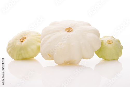 three young and fresh white pattypan squashes