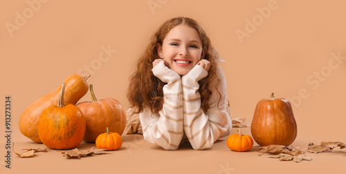 Young woman with pumpkins a...