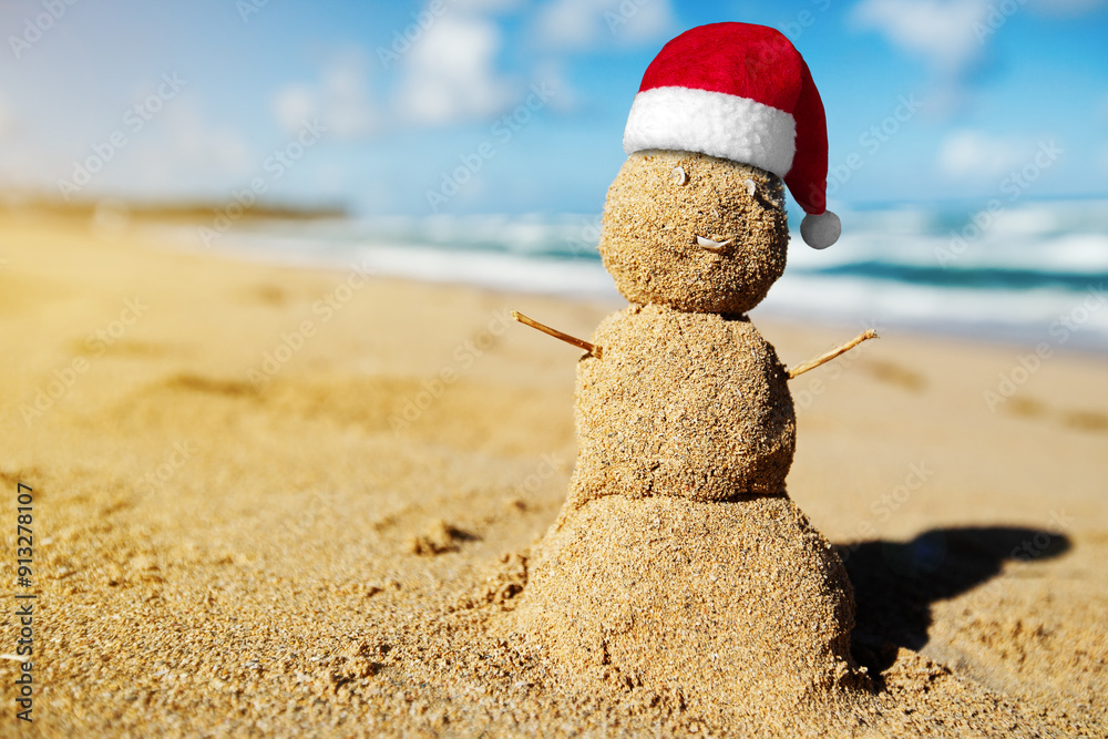 Caribbean Christmas Snowman with Santa Claus Hat made out of sand on sandy beach. Holiday vacation. New Year travel greeting card Caribbean Christmas Snowman with Santa Claus Hat made out of sand on sandy beach. Holiday vacation. New Year travel greeting card
