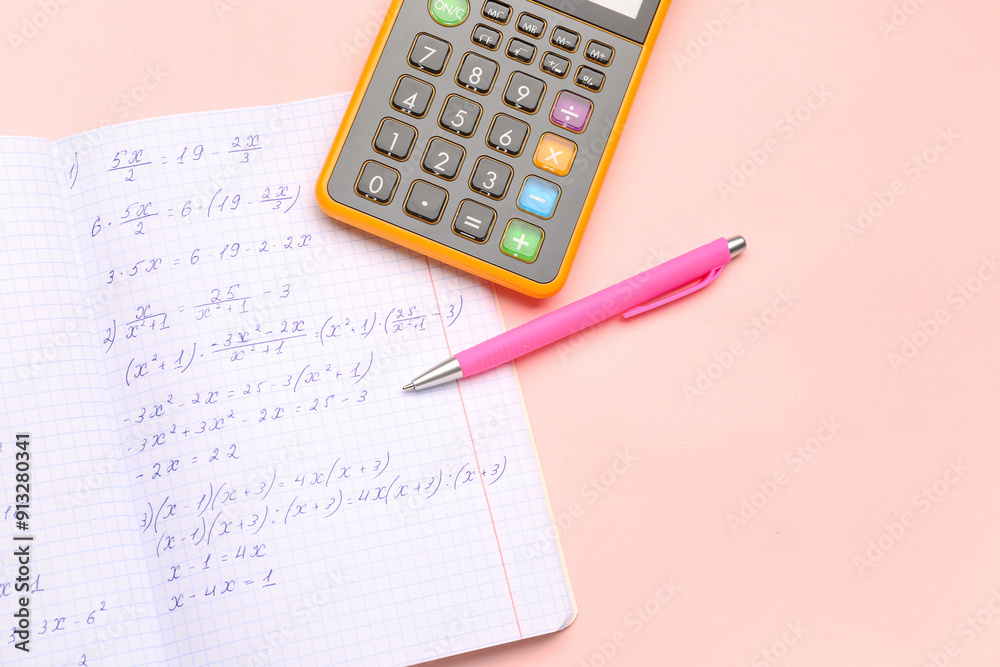 Copybook with maths formulas, pen and calculator on pink background Copybook with maths formulas, pen and calculator on pink background