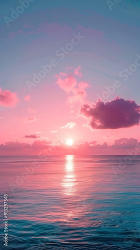 A vibrant pink and blue sunset over the ocean, with clouds reflecting the colors.