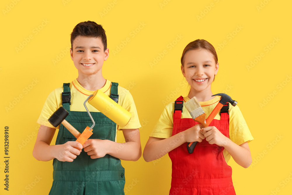 Little architects with tools on yellow background Little architects with tools on yellow background