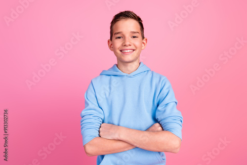 Photo portrait of cute teen boy crossed hands confident dressed stylish blue clothes isolated on pink color background photo