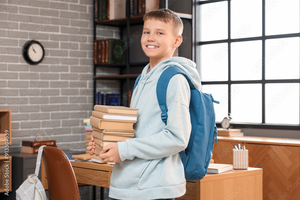 © Pixel-Shot - Teenage boy with backpack and books in library