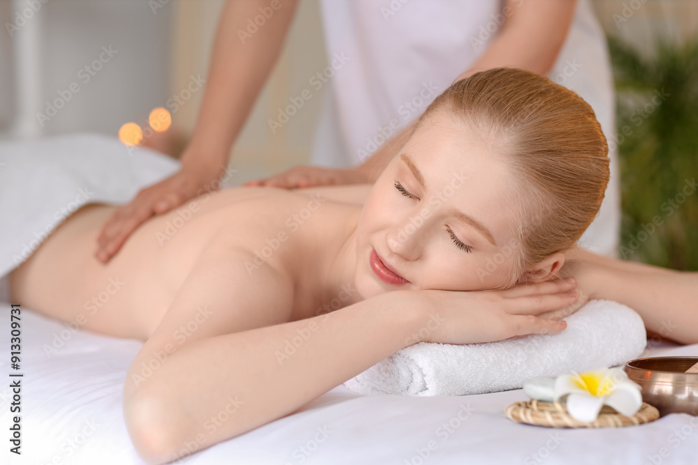 Young woman enjoying spine massage with essential oil in spa salon Young woman enjoying spine massage with essential oil in spa salon