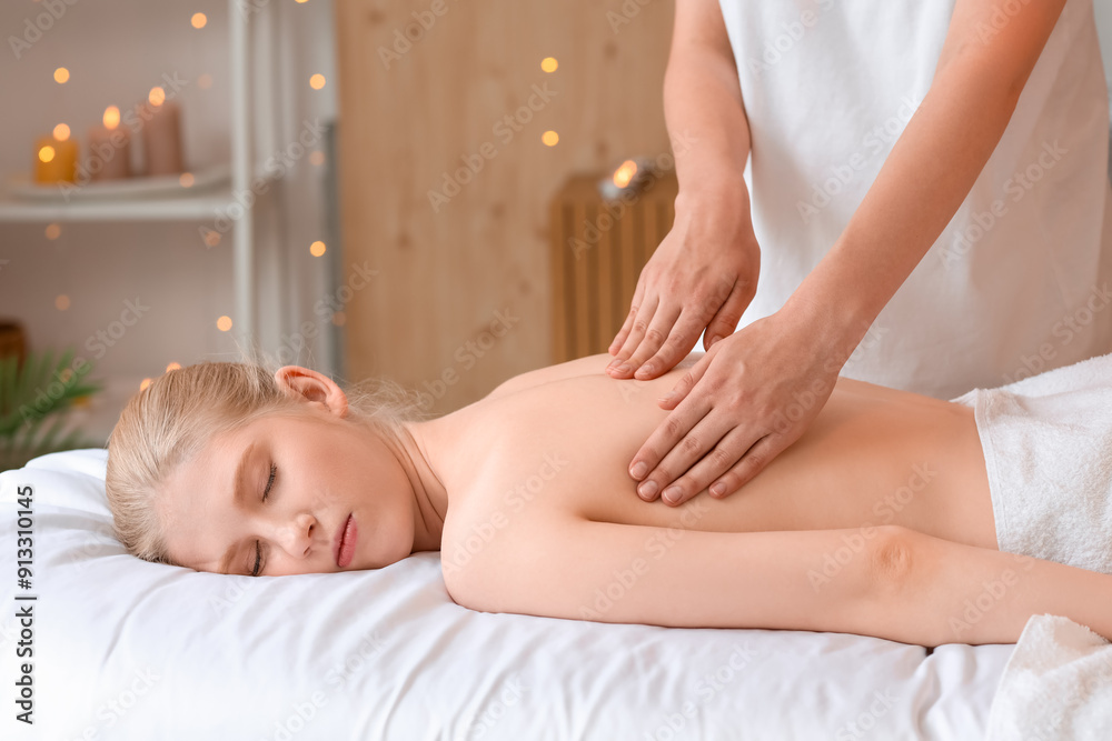 Obraz premium Young woman enjoying massage in spa salon