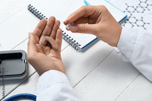 Hands of female doctor with...