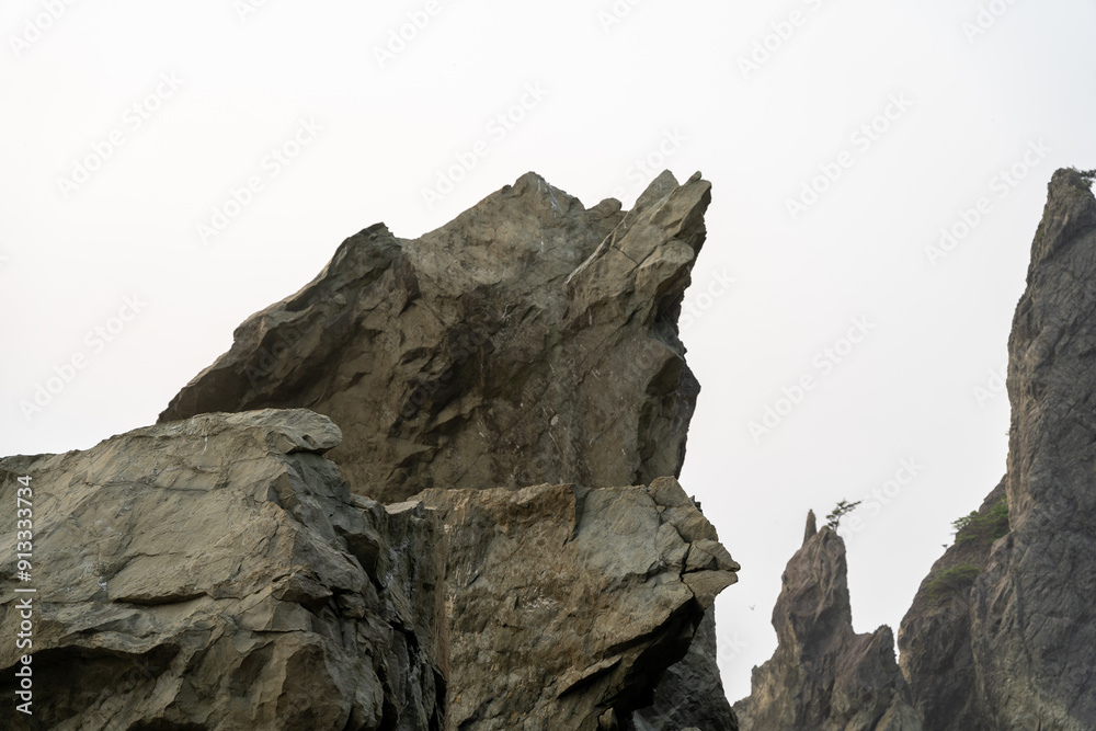 A beautiful view of giant rocks and ocean at Rialto Beach on a cloud day. A beautiful view of giant rocks and ocean at Rialto Beach on a cloud day.