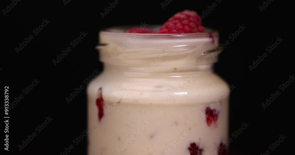 delicious and fresh yogurt with raspberry flavor and whole red raspberries, raspberry yogurt on the table