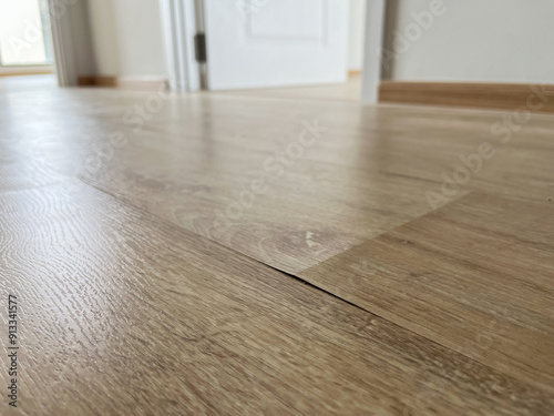 The laminate flooring in the room was damaged due to water penetrating the wood for too long.