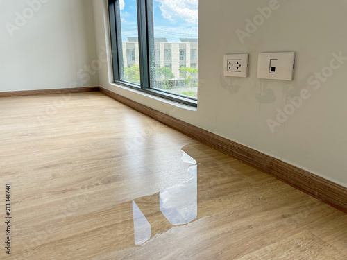 The laminate floor inside the room was damaged by rainwater leaking into the house.